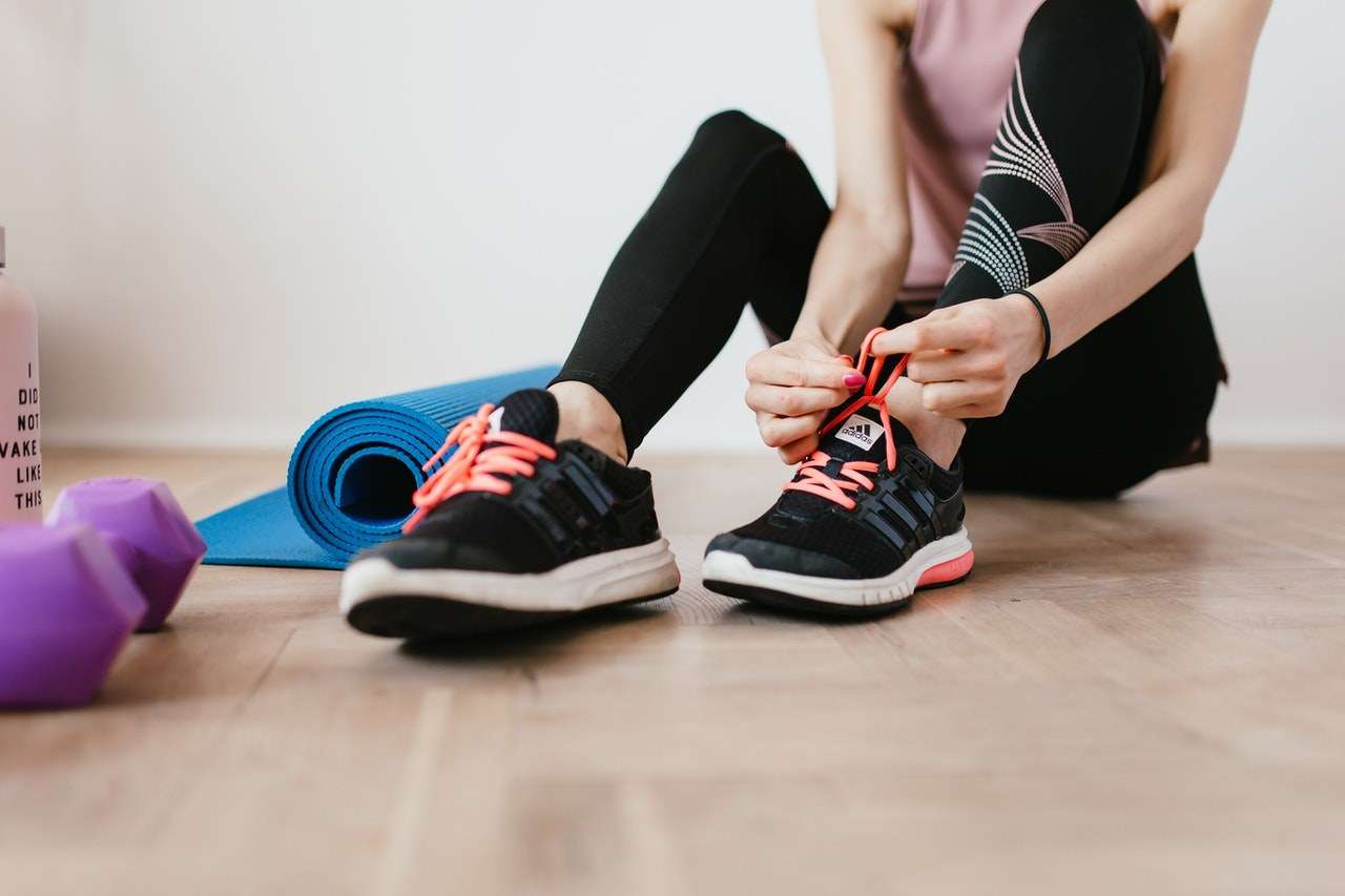 Student tying up her trainers